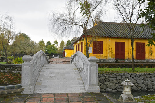 Ta Vu also known as Left House and a bridge over the lake in the grounds in Truong Sanh Residence in the Imperial City, Hue, Vietnam
