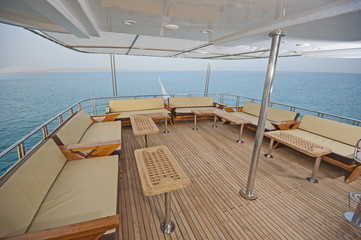 Table and chairs on deck of a luxury motor yacht