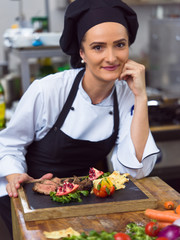 female Chef preparing beef steak