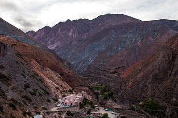 View of Iruya village and multicolored mountains in the surroundings at sunset, Salta province, Argentina, iruya - San Isidro - San Juan treeking