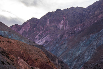 View of Iruya village and multicolored mountains in the surroundings at sunset, Salta province, Argentina, iruya - San Isidro - San Juan treeking