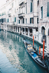 little waterways in venice with empty gondola