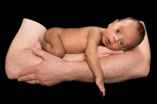 Biracial baby on fathers arms