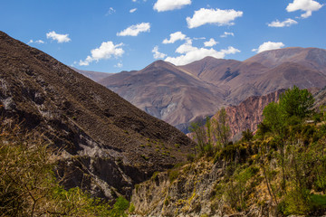 View of Iruya village and multicolored mountains in the surroundings at sunset, Salta province, Argentina, iruya - San Isidro - San Juan treeking