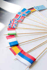Bunch of miniature paper flags of several countries: Greece,Germany,Sweden,Norway,England,Italy,France,Spain, Russia