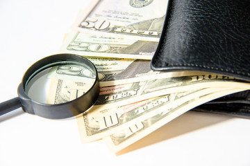 Money, hundred american dollars in black leather purse on white background