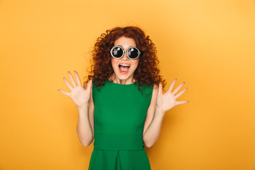 Close up portrait of a curly redhead woman in sunglasses