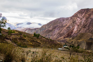 View of Iruya village and multicolored mountains in the surroundings at sunset, Salta province, Argentina, iruya - San Isidro - San Juan treeking