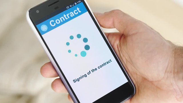 Signing a digital contract on a smartphone device screen.