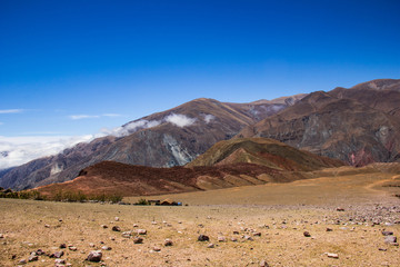 View of Iruya village and multicolored mountains in the surroundings at sunset, Salta province, Argentina, iruya - San Isidro - San Juan treeking