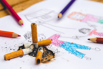 Crayon painting is a family image from the child's imagination. The father image is burned with cigarettes butts.
