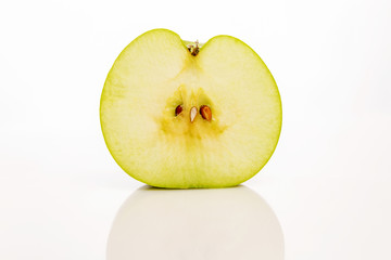 A windy cut of half a green apple with bones, close-up, isolated on white background