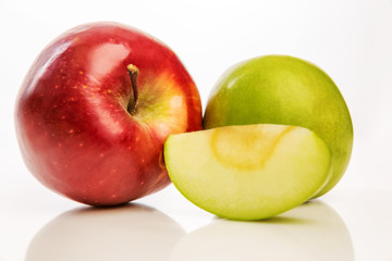Bright red and green apples, close-up, isolated on white background
