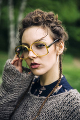 Pretty young woman with eyeglasses in the forest
