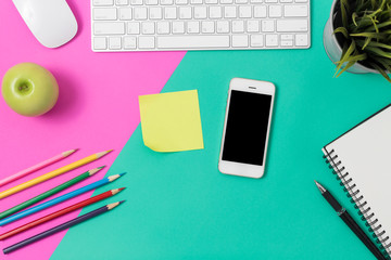 Top view office desk with smartphone, computer and office supplies  with sticky note