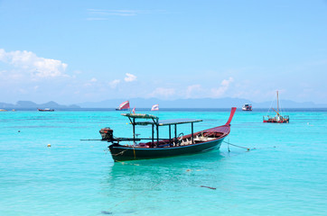 Naklejka na ściany i meble Turquoise sea And blue sky White Sand Beach with taxi long tail boat, travel concept. Koh Lipe, Satun, Thailand