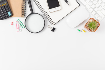 office desk with smartphone, computer and office supplies top view