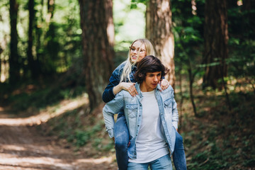 Happy young couple having fun in forest