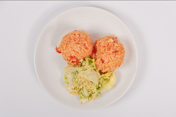 Tomato rice and salad on a white