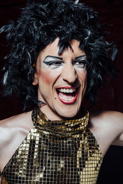 Transgender make up man dressed like a girl, looking at camera with surprise face