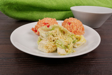 Tomato rice and salad on a table