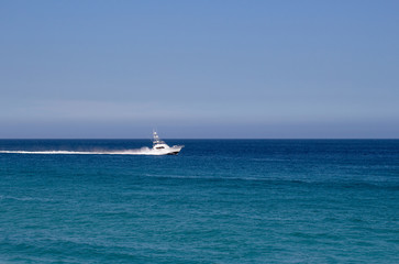 Yacht traveling in the open blue ocean and blue sky in Mexico