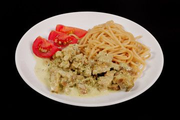Spaghetti with tempeh and herb sauce on a black