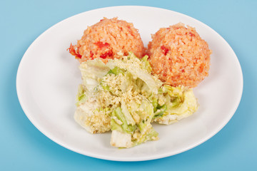 Tomato rice and salad on a blue
