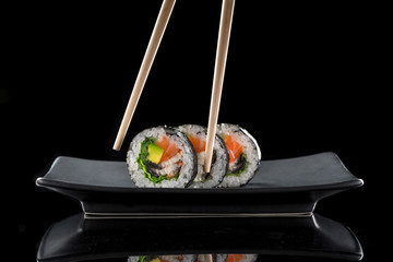 sushi on the black background © mateusz