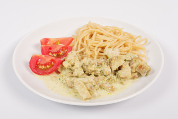Spaghetti with tempeh and herb sauce on a white