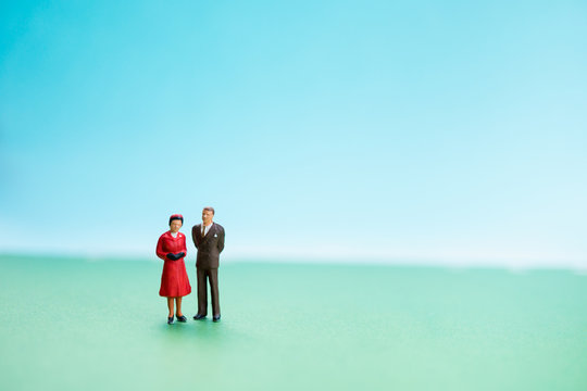 Miniature people, husband and wife standing action using as family concept