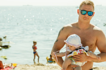 Man posing with baby on summer
