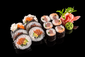 sushi rolls isolated on the black background © mateusz