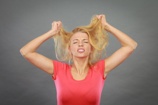 Frustrated Woman Holding Her Damaged Blonde Hair