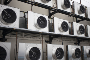 large metal air conditioners on the roof of the building
