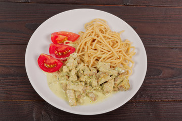 Spaghetti with tempeh and herb sauce on a table