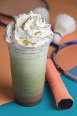 plastic glass of mixed ice macha green tea ,coffee ,milk with whip cream topping