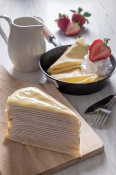 sweet delicious dessert , fresh crepe cake and whipcream with red strawberry