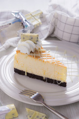 sweet delicious dessert , white chocolate cheescake on plate