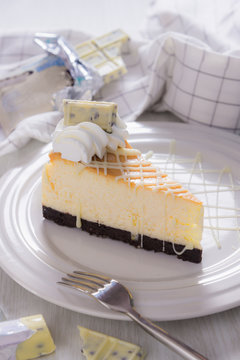 sweet delicious dessert , white chocolate cheescake on plate