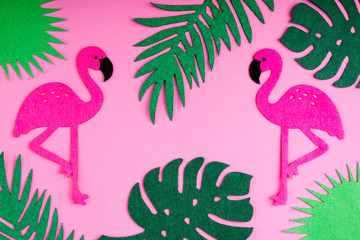 Summer trendy background with flamingo and leaves on pink. Handmade palm leaves and birds. Felt toy. Idea summer art crafts for kids in camp arts. Top view
