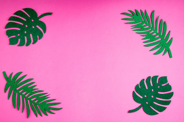 Fototapeta na wymiar Summer trendy background with leaves on pink. Handmade palm leaves. Felt toy. Idea summer art crafts for kids in camp arts. Top view