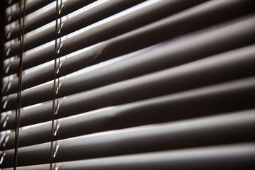 Blinds in a home catching the sunlight,metal shutter window background.Blinds. Window blind. Blind Background