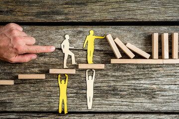 Teamwork and stopping the domino effect concept with paper cutouts of men