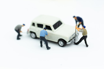 Miniature people : Workers are repairing car. Image use for engine maintenance, car care.