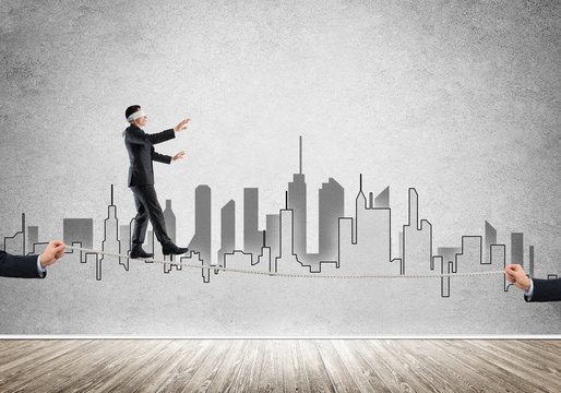 Business concept of risk support and assistance with man balancing on rope