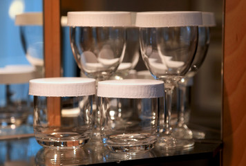 Glasses are in the rack with lids on it.