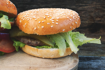A beautiful homemade hamburger on a rustic wooden background