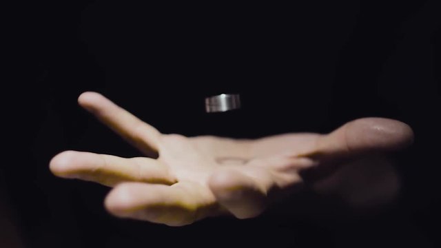 The trick with the ring. Levitation ring in the hand of the magician. Ring hangs in the air. Slow motion.