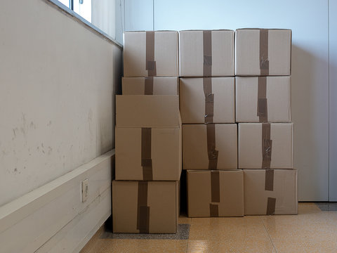 Cardboard boxes stacked against the wall